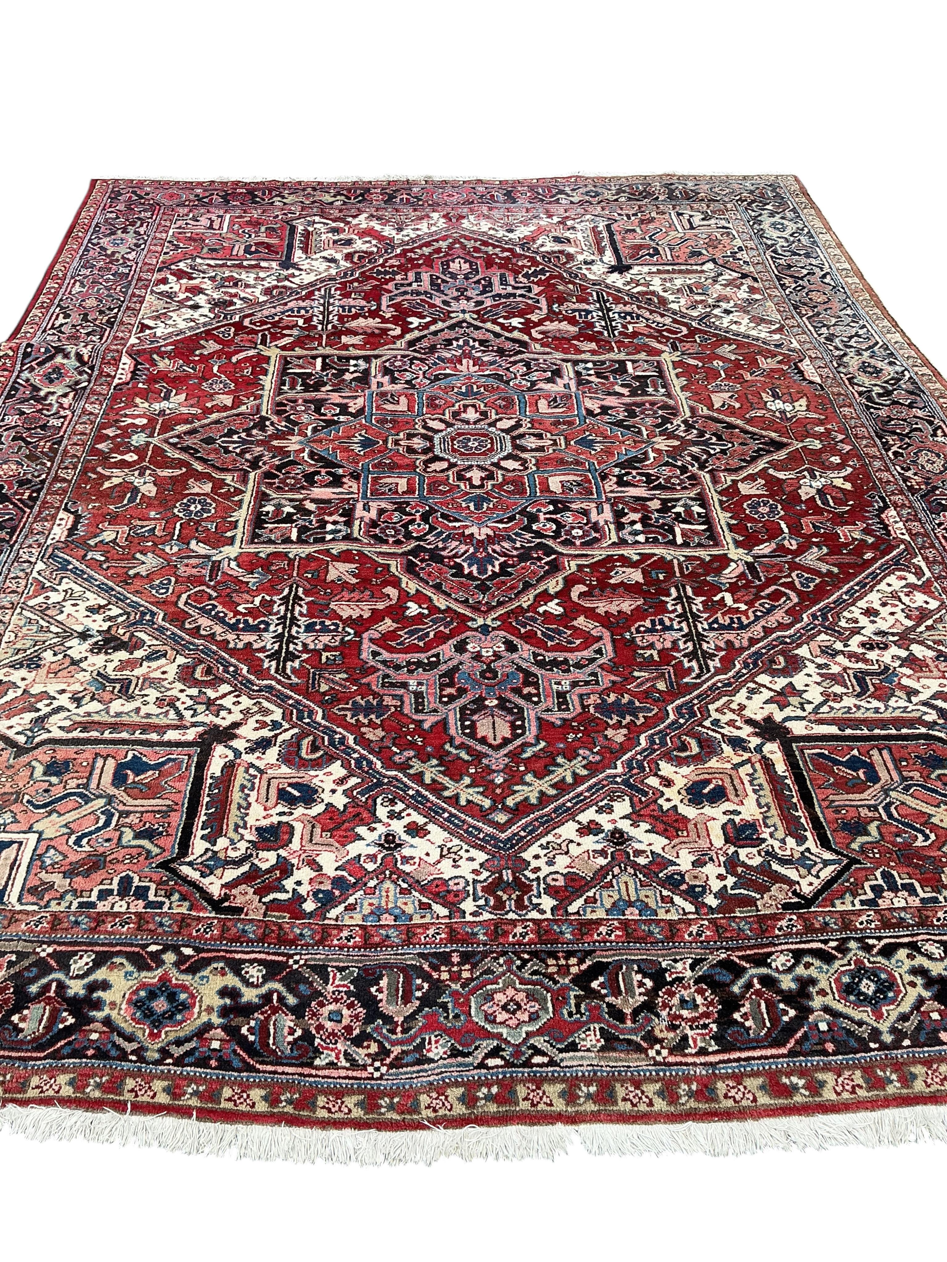 A Heriz red ground carpet, 345 x 265cm